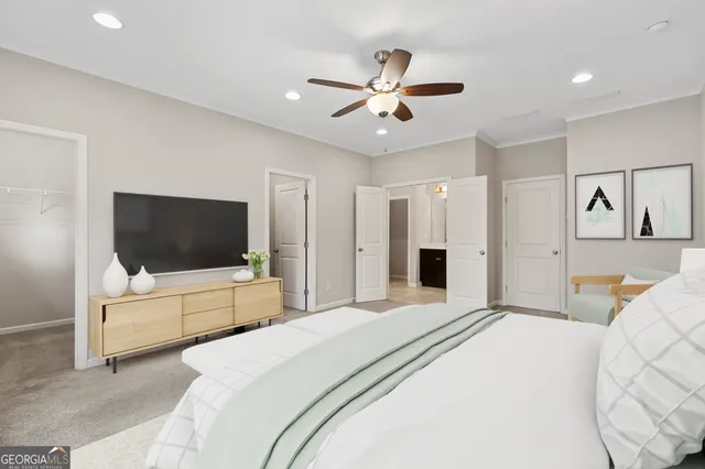 a bedroom with a bed and a flat screen tv