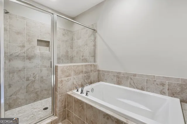 a bathroom with a bathtub and shower