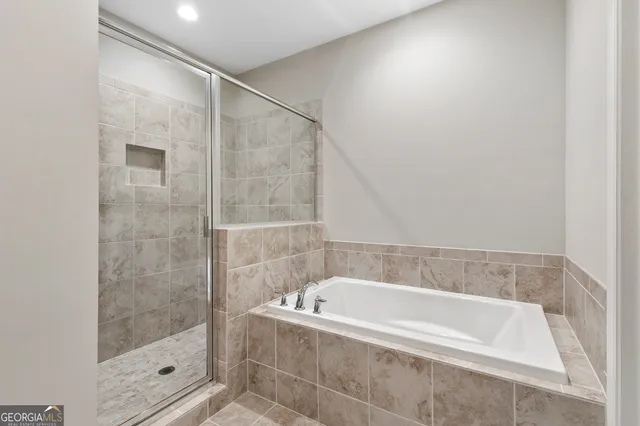 a bathroom with a bathtub and shower