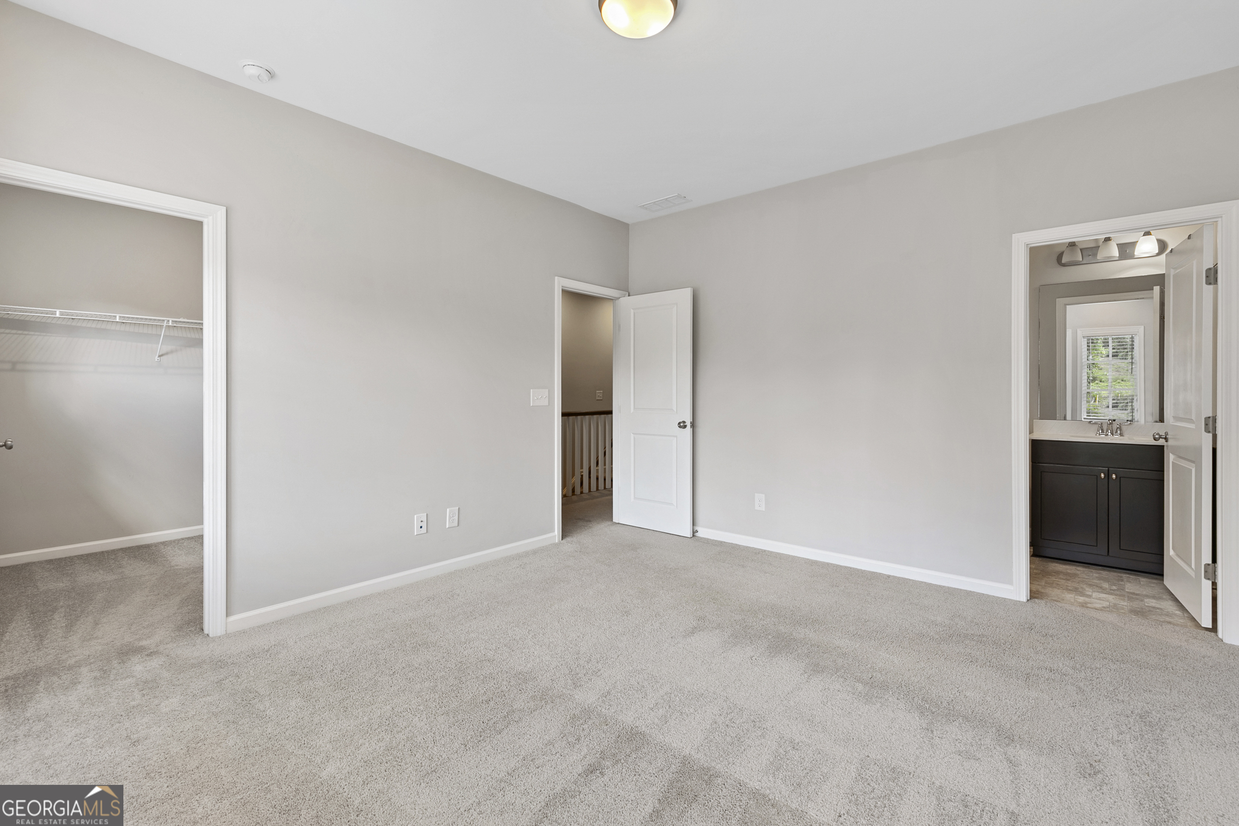 1954 Summit Trace Circle Northwest Atlanta, GA 30318 - Photo 30 of 45 an empty room with closet and mirror