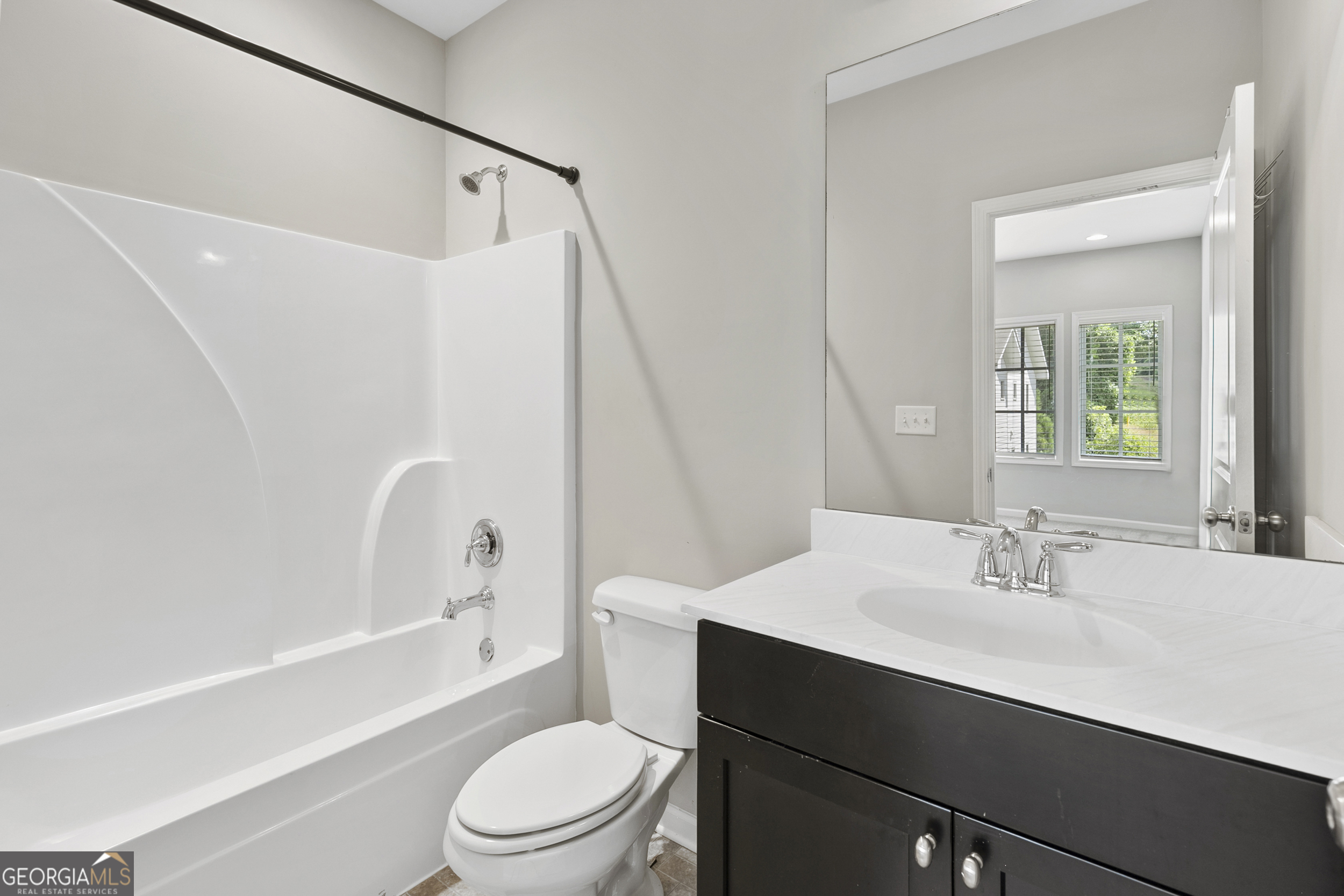 1954 Summit Trace Circle Northwest Atlanta, GA 30318 - Photo 35 of 45 a bathroom with a sink a toilet and shower