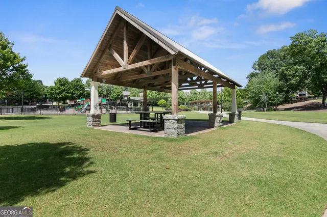a view of a house with backyard and sitting area