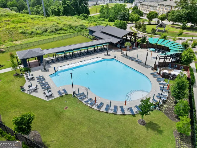 an aerial view of a house with a garden and swimming pool