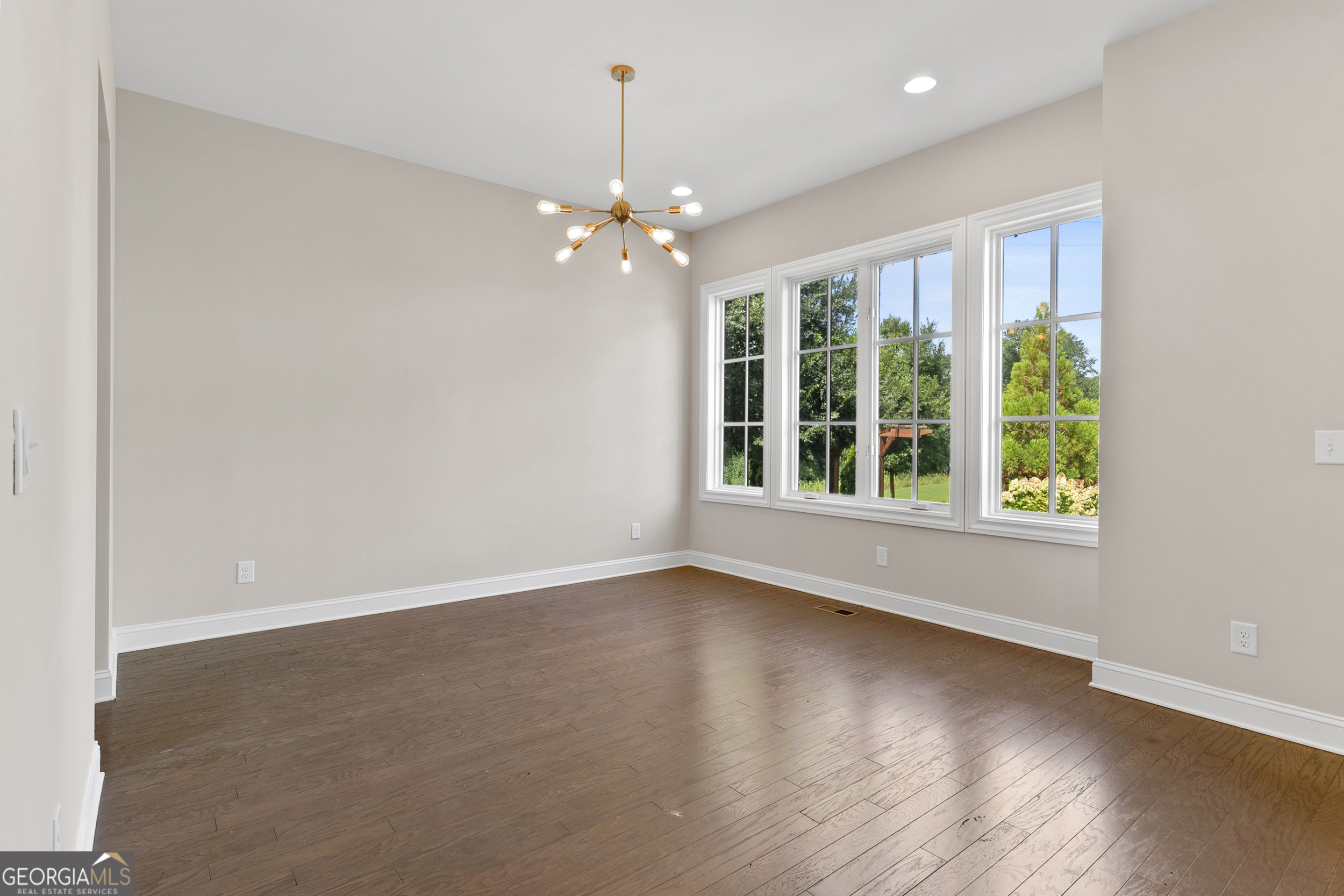 1954 Summit Trace Circle Northwest Atlanta, GA 30318 - Photo 7 of 45 an empty room with wooden floor and windows