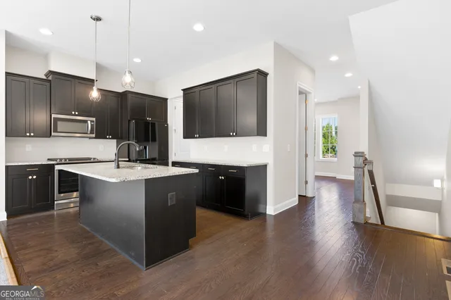 a large kitchen with a large counter top appliances and cabinets