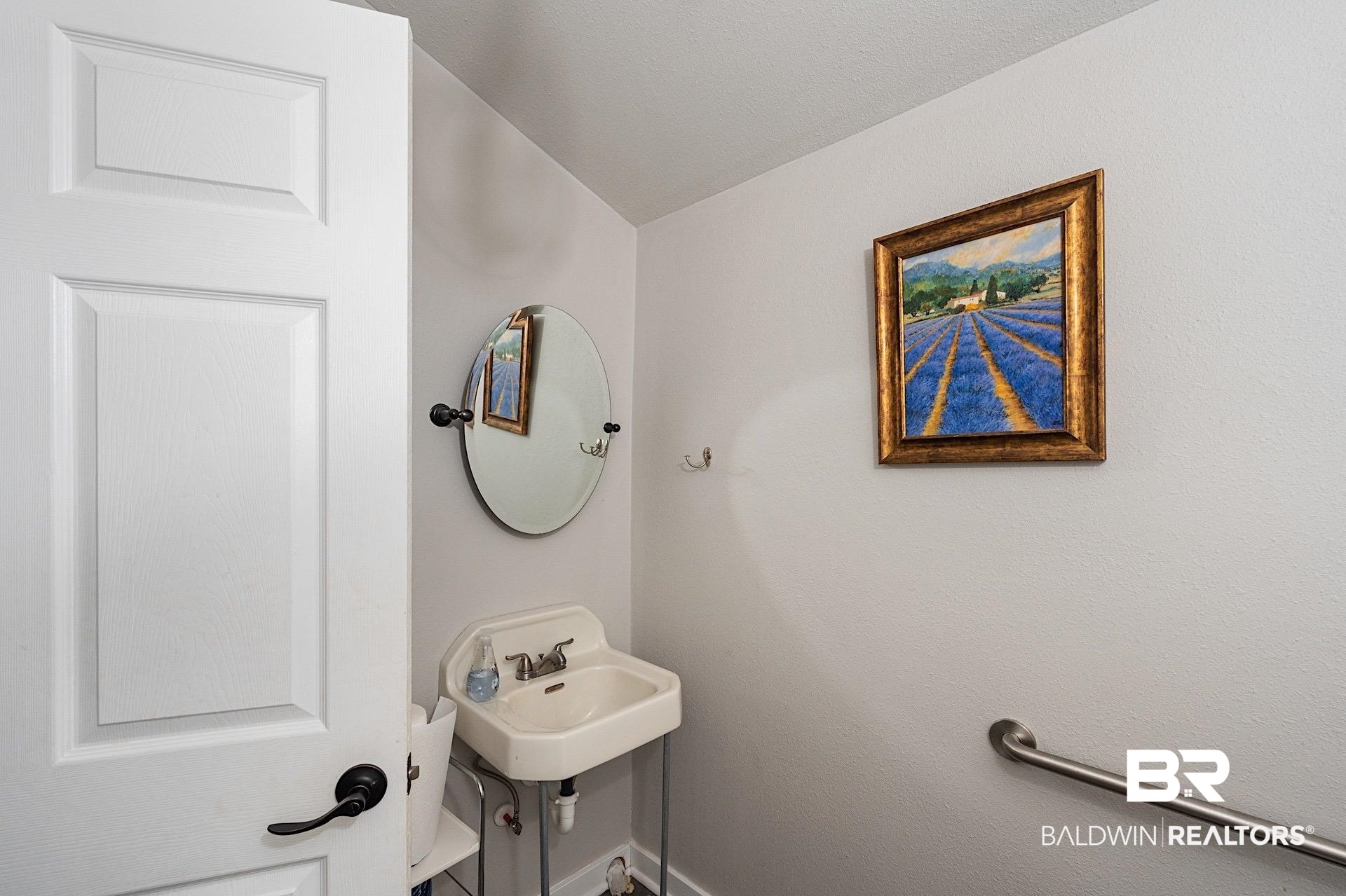 22051 Broad Street Silverhill, AL 36576 - Photo 13 of 28 Bathroom featuring sink and vaulted ceiling