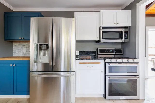 a view of a kitchen with a refrigerator and a sink
