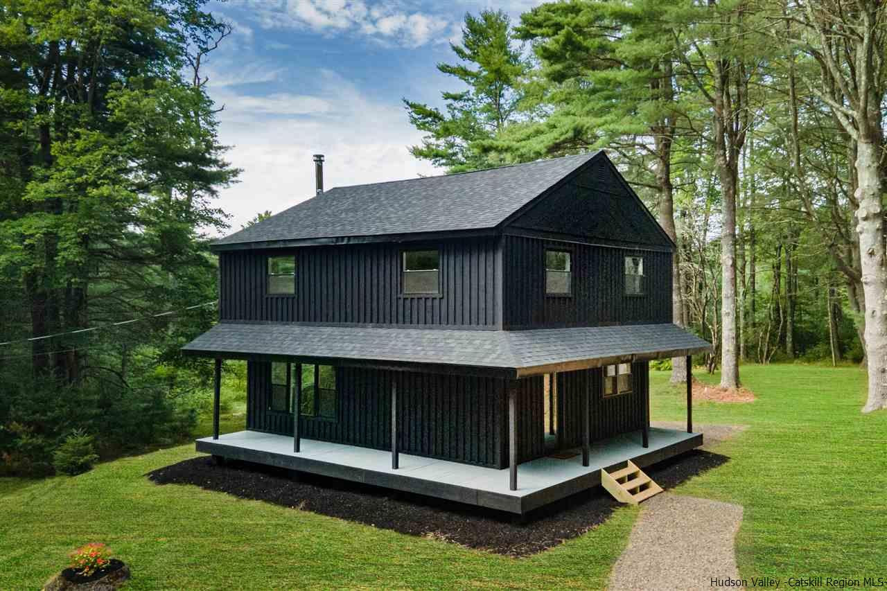 a front view of a house with a yard balcony