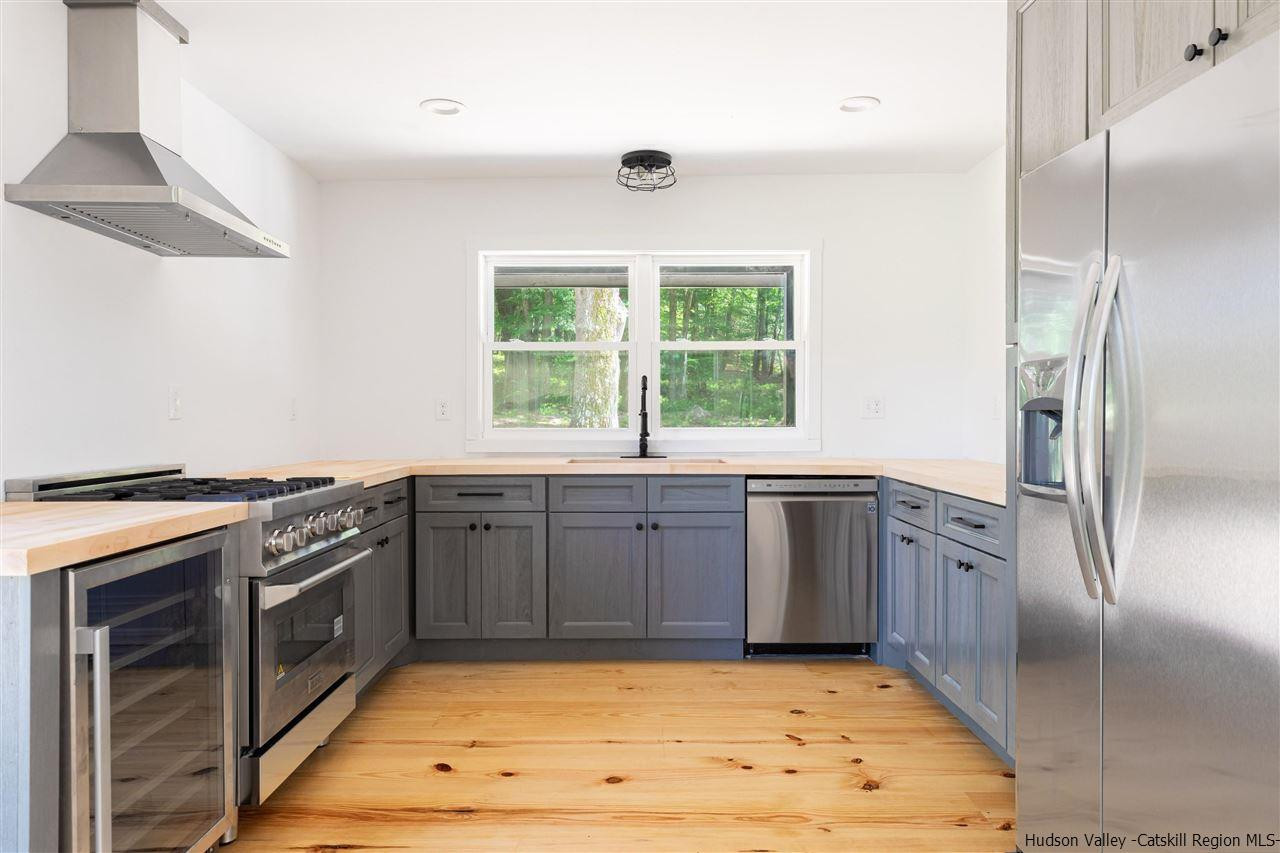 5646 Red Hill Road Claryville, NY 12725 - Photo 12 of 35 a kitchen with stainless steel appliances granite countertop a stove a sink and a refrigerator