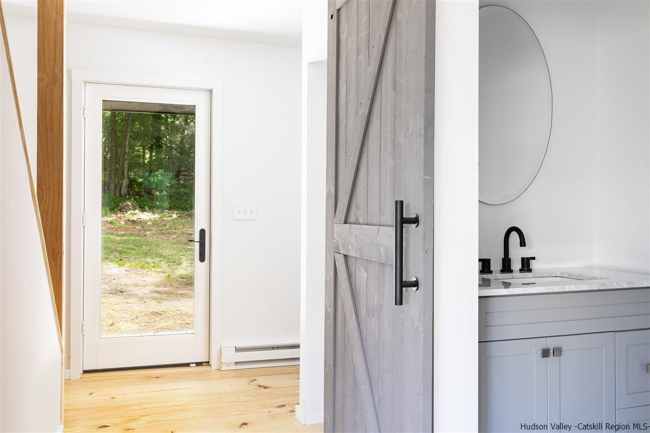 5646 Red Hill Road Claryville, NY 12725 - Photo 14 of 35 a bathroom with a sink a mirror a vanity and shower