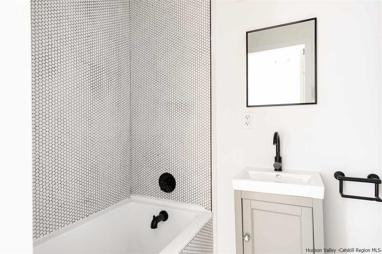 5646 Red Hill Road Claryville, NY 12725 - Photo 20 of 35 a bathroom with a bathtub and a sink