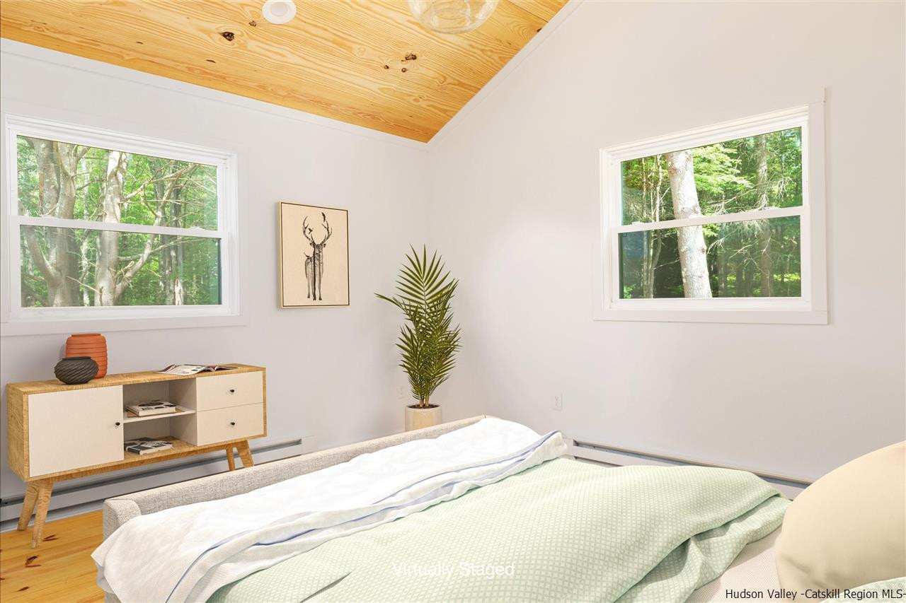 5646 Red Hill Road Claryville, NY 12725 - Photo 22 of 35 a bedroom with a bed and a window