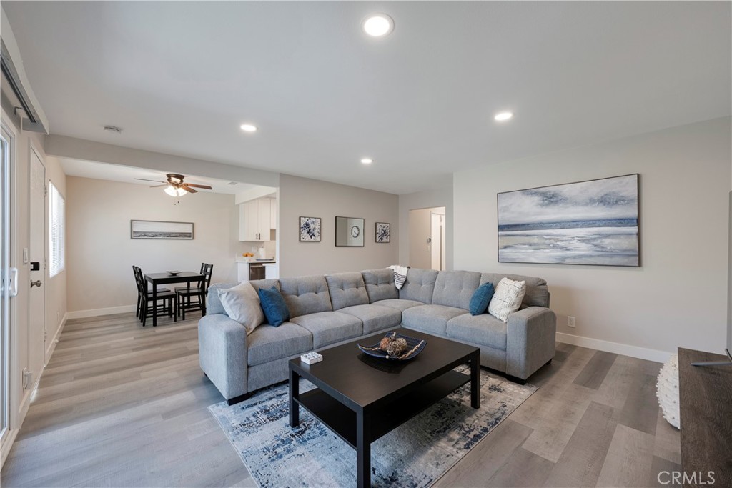 Open concept family room with sectional sofa and smart TV