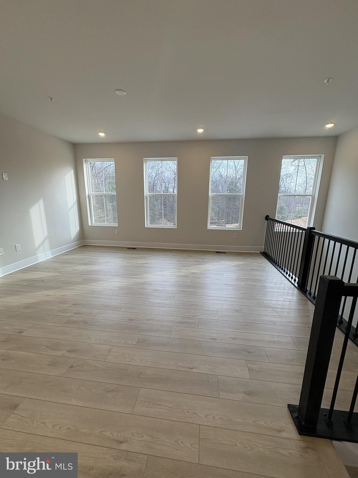 7450 Cornerstone Way Laurel, MD 20707 - Photo 5 of 14 an empty room with wooden floor and windows