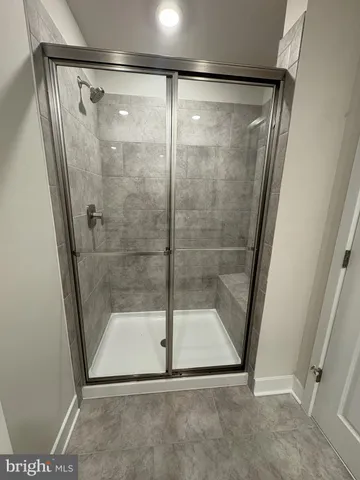 a bathroom with a glass door shower