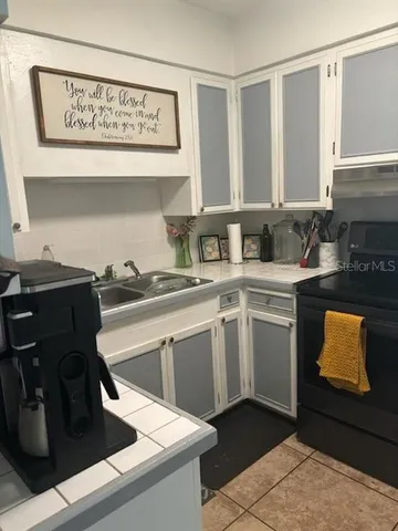 a kitchen with a sink and cabinets