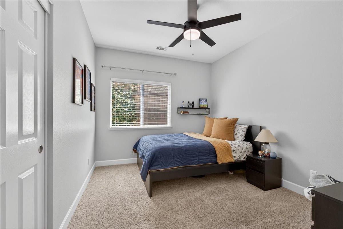 437 Silver Ridge Court Oakdale, CA 95361 - Photo 23 of 41 a bedroom with a bed ceiling fan and window