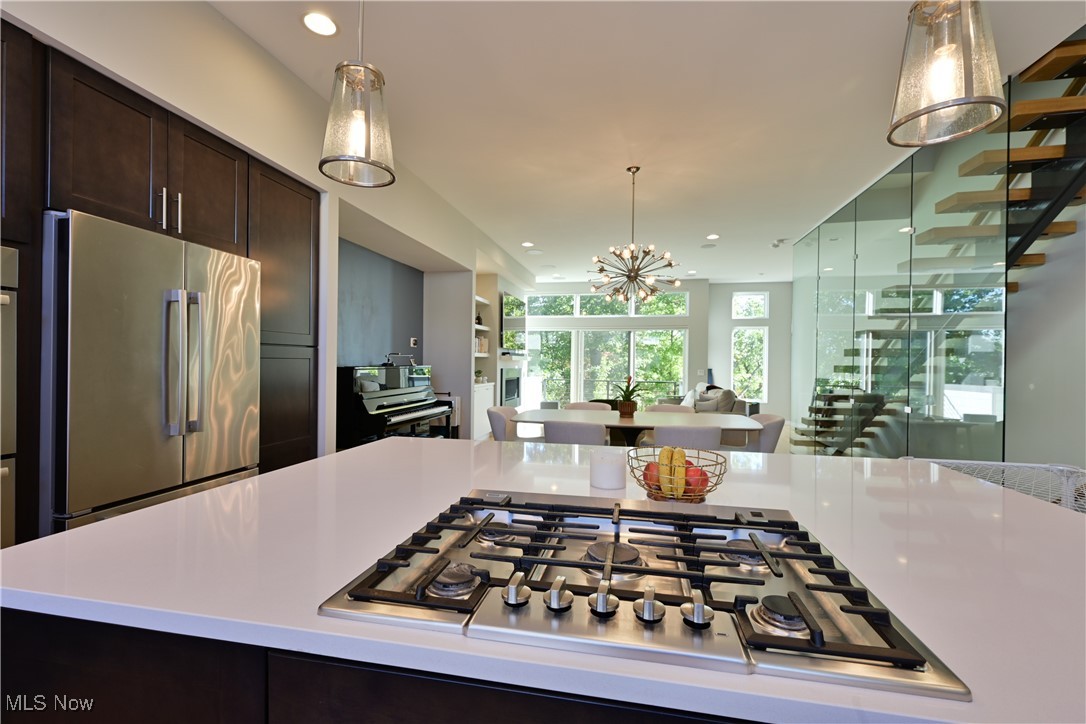 18875 Riversouth Fairview Park, Unit 30 Cleveland, OH 44126 - Photo 12 of 39 Kitchen with appliances with stainless steel finishes, dark brown cabinetry, hanging light fixtures, a chandelier, and recessed lighting