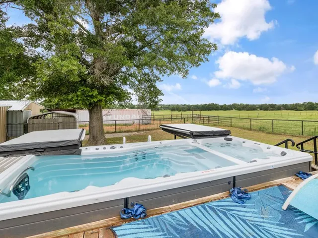 a view of a swimming pool with outdoor seating