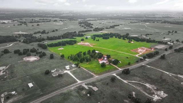 an aerial view of a golf course with parking space