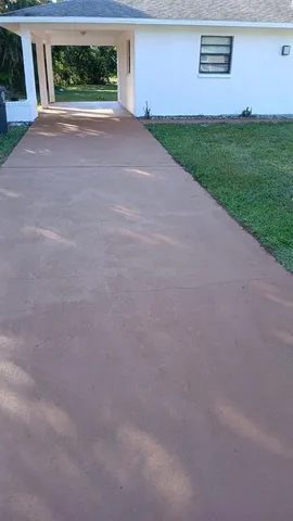 a view of a house with a yard and a garage