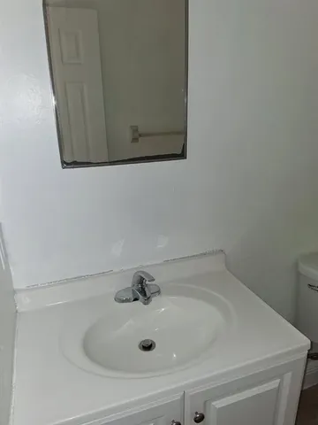 a bathroom with a sink and mirror