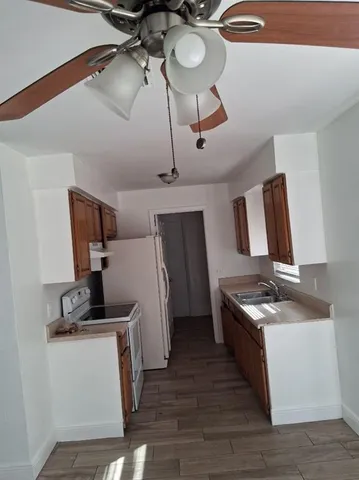 a kitchen with stainless steel appliances granite countertop a sink dishwasher stove and refrigerator