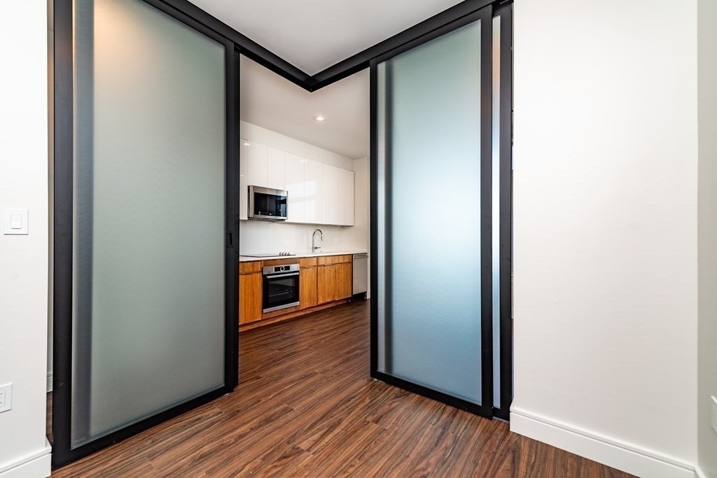 99 Sumner Street, Unit 413 Boston, MA 02128 - Photo 4 of 17 a view of a kitchen from a hallway