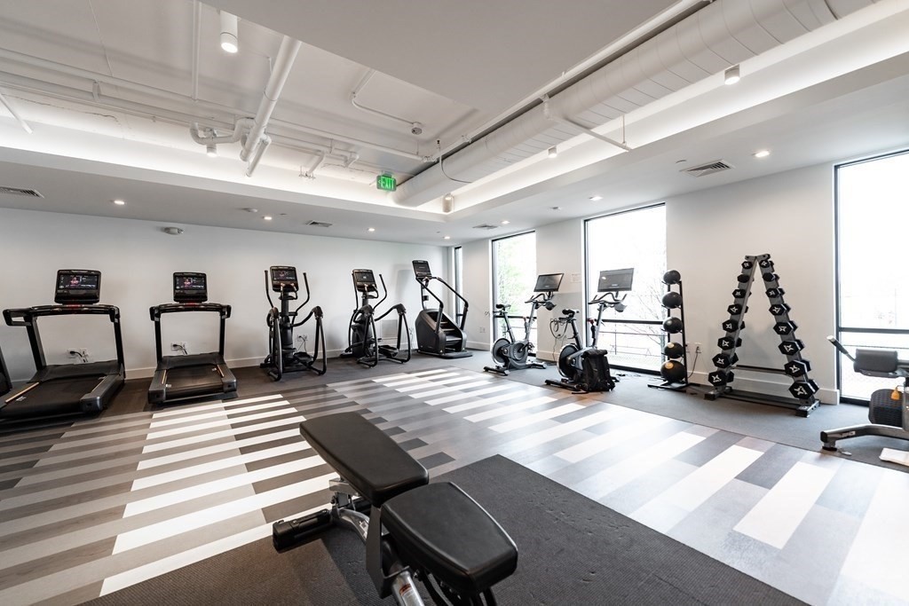99 Sumner Street, Unit 413 Boston, MA 02128 - Photo 9 of 17 a living room with lots of furniture and a large window