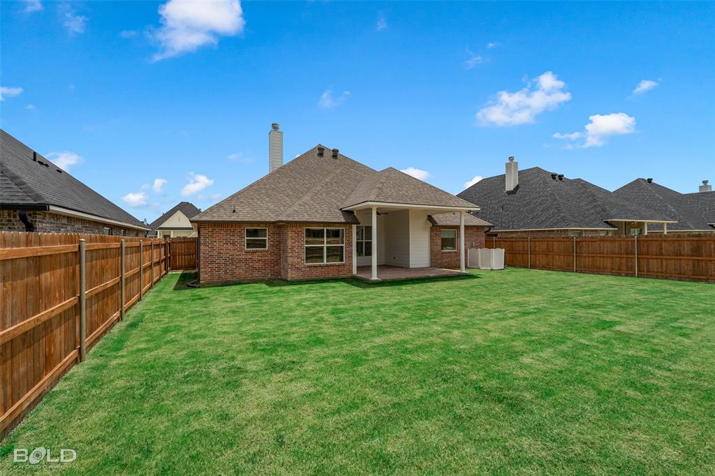 304 Prien Lk Loop Bossier City, LA 71111 - Photo 35 of 39 Spacious backyard featuring a covered patio, red brick exterior, and a privacy fence