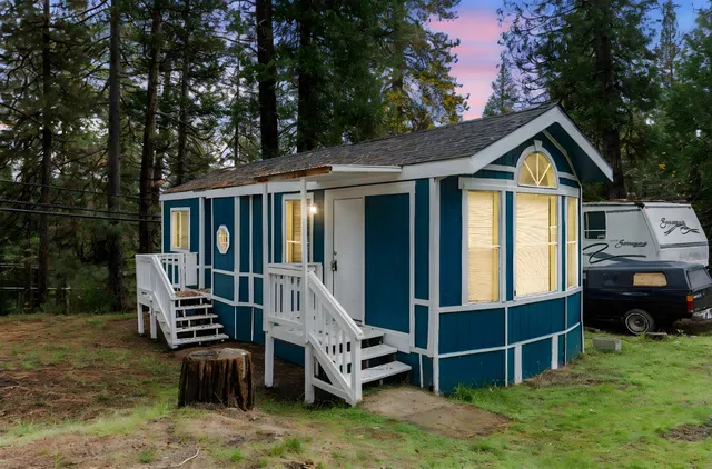 a front view of a house with a yard table and chairs