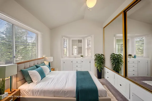 a spacious bedroom with a large bed and a large window