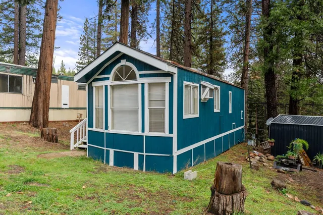 a view of an house with backyard outdoor seating and deck