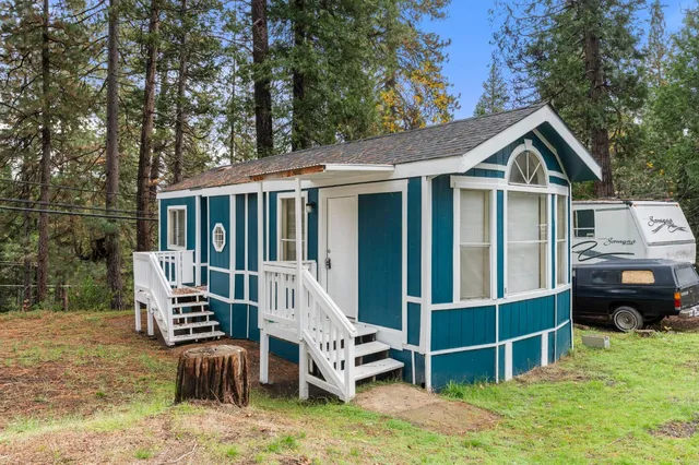 a front view of a house with a yard and balcony