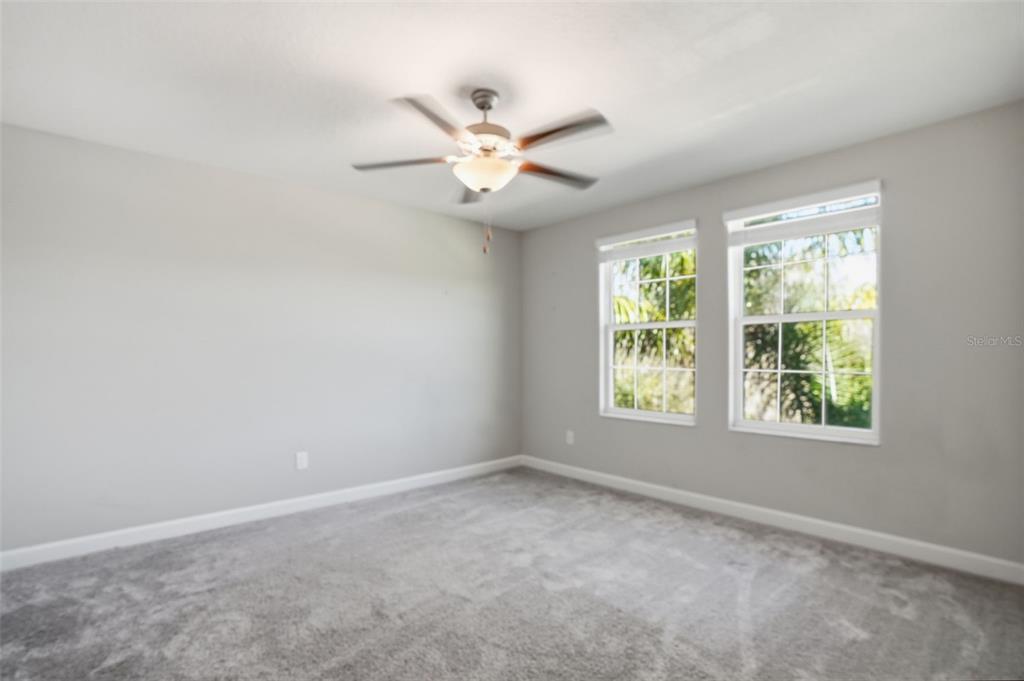8676 Capstone Ranch Drive New Port Richey, FL 34655 - Photo 14 of 47 an empty room with windows and fan