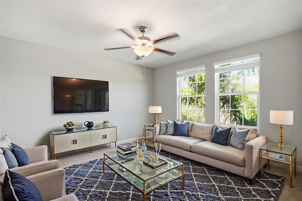 8676 Capstone Ranch Drive New Port Richey, FL 34655 - Photo 15 of 47 a living room with furniture a flat screen tv and a window