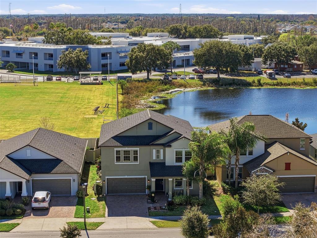 8676 Capstone Ranch Drive New Port Richey, FL 34655 - Photo 2 of 47 an aerial view of a house with pool lawn chairs and large tree