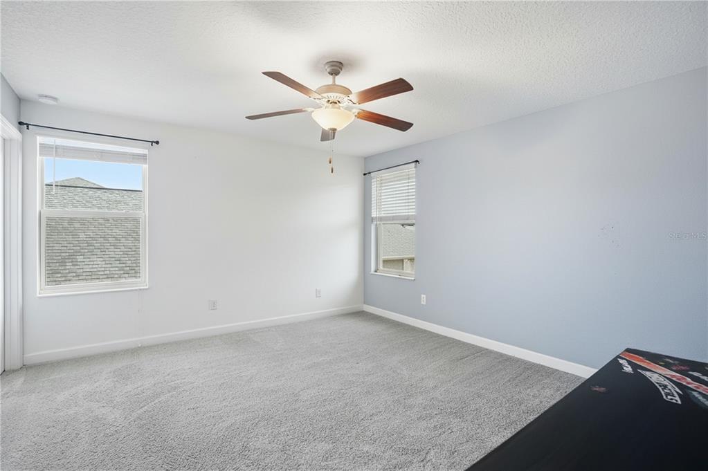 8676 Capstone Ranch Drive New Port Richey, FL 34655 - Photo 31 of 47 an empty room with windows and fan