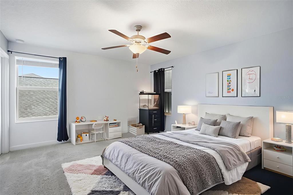 8676 Capstone Ranch Drive New Port Richey, FL 34655 - Photo 34 of 47 a bedroom with a bed and a chandelier