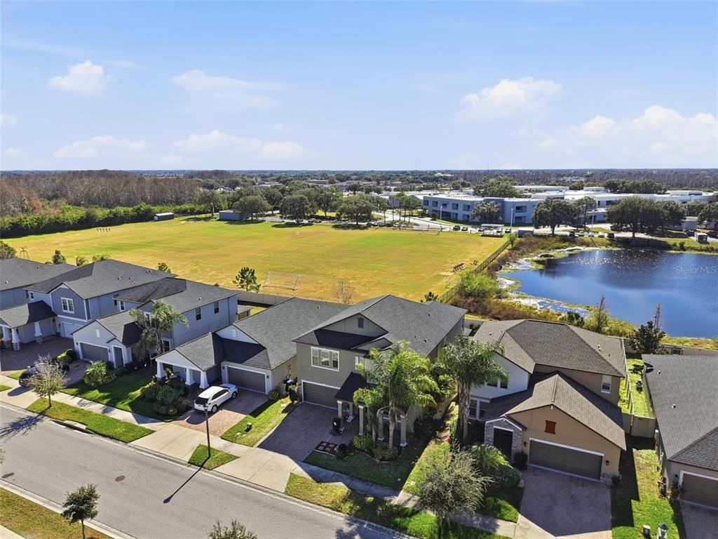 8676 Capstone Ranch Drive New Port Richey, FL 34655 - Photo 42 of 47 an aerial view of residential houses with outdoor space and lake view