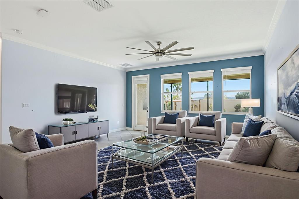 8676 Capstone Ranch Drive New Port Richey, FL 34655 - Photo 5 of 47 a living room with furniture a flat screen tv and a large window