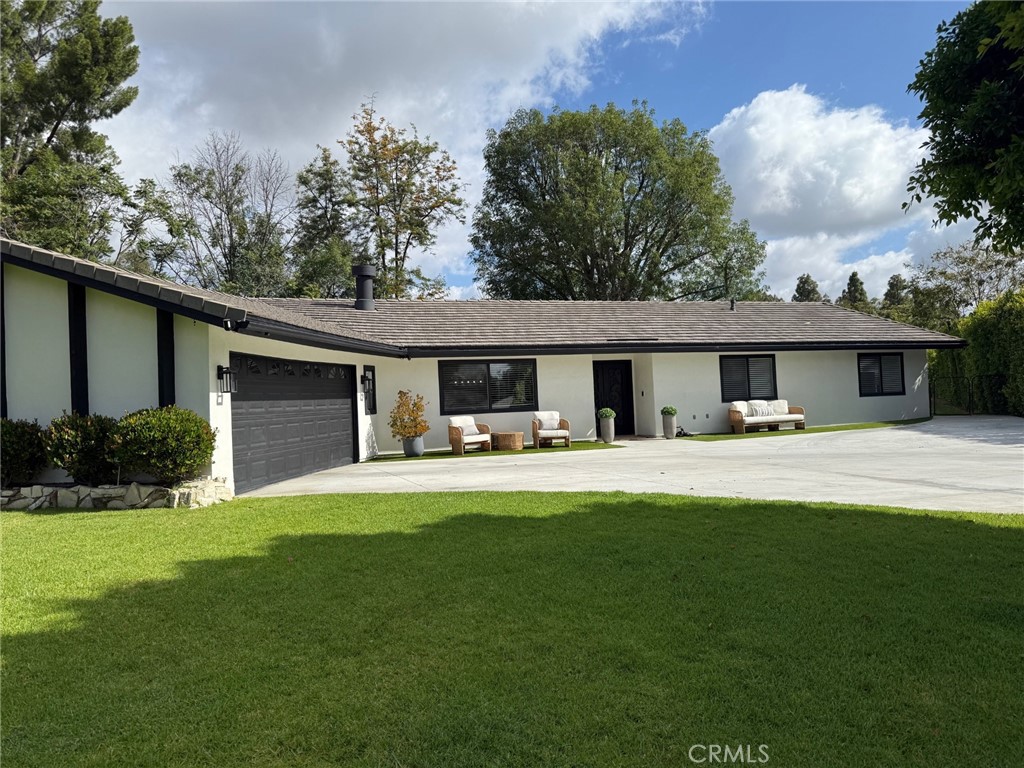 a front view of a house with swimming pool having outdoor seating