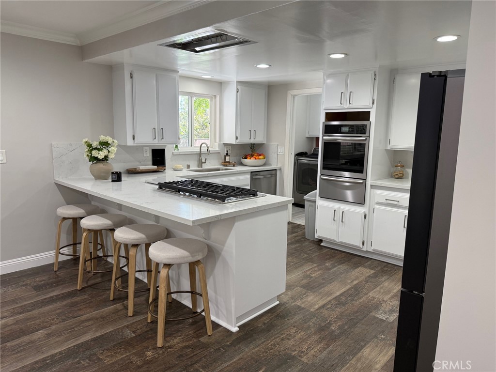 1530 Robin Way Fullerton, CA 92835 - Photo 16 of 35 a kitchen with white cabinets and appliances