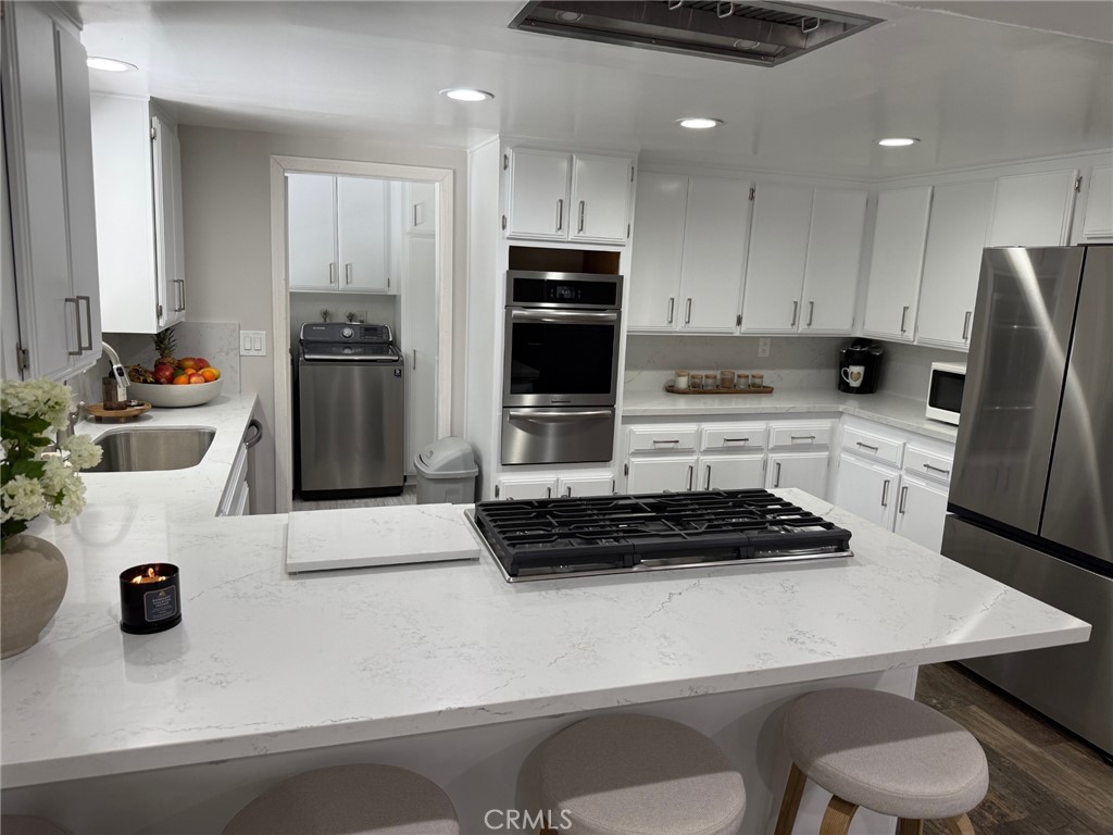 1530 Robin Way Fullerton, CA 92835 - Photo 20 of 35 a kitchen with a refrigerator a stove a sink and a stove