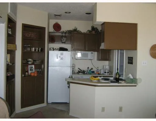 a kitchen with refrigerator and cabinets