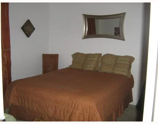 a bedroom with a bed and a tv