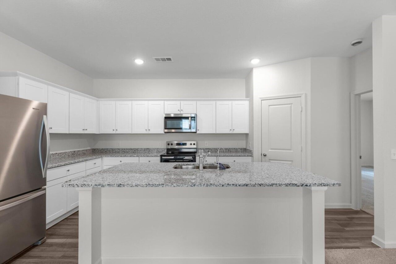 3107 Diamond Vw Lane Angleton, TX 77515 - Photo 2 of 14 a kitchen with stainless steel appliances granite countertop a refrigerator a stove and white cabinets