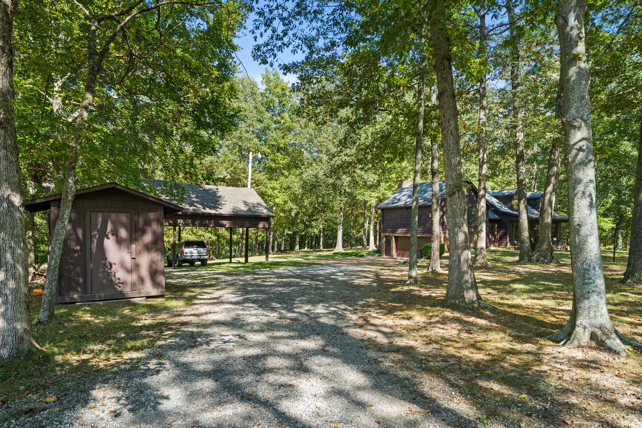 6516 Greenbrier Cemetery Road Greenbrier, TN 37073 - Photo 46 of 64 a backyard of a house with barbeque oven and trees