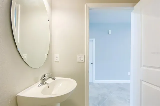 an empty room with kitchen view