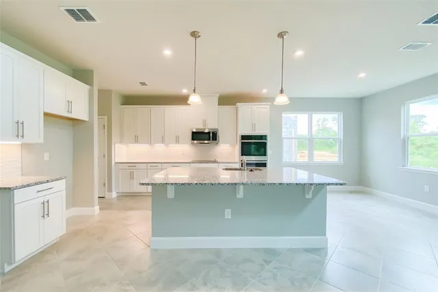 a bathroom with a sink a vanity and a mirror